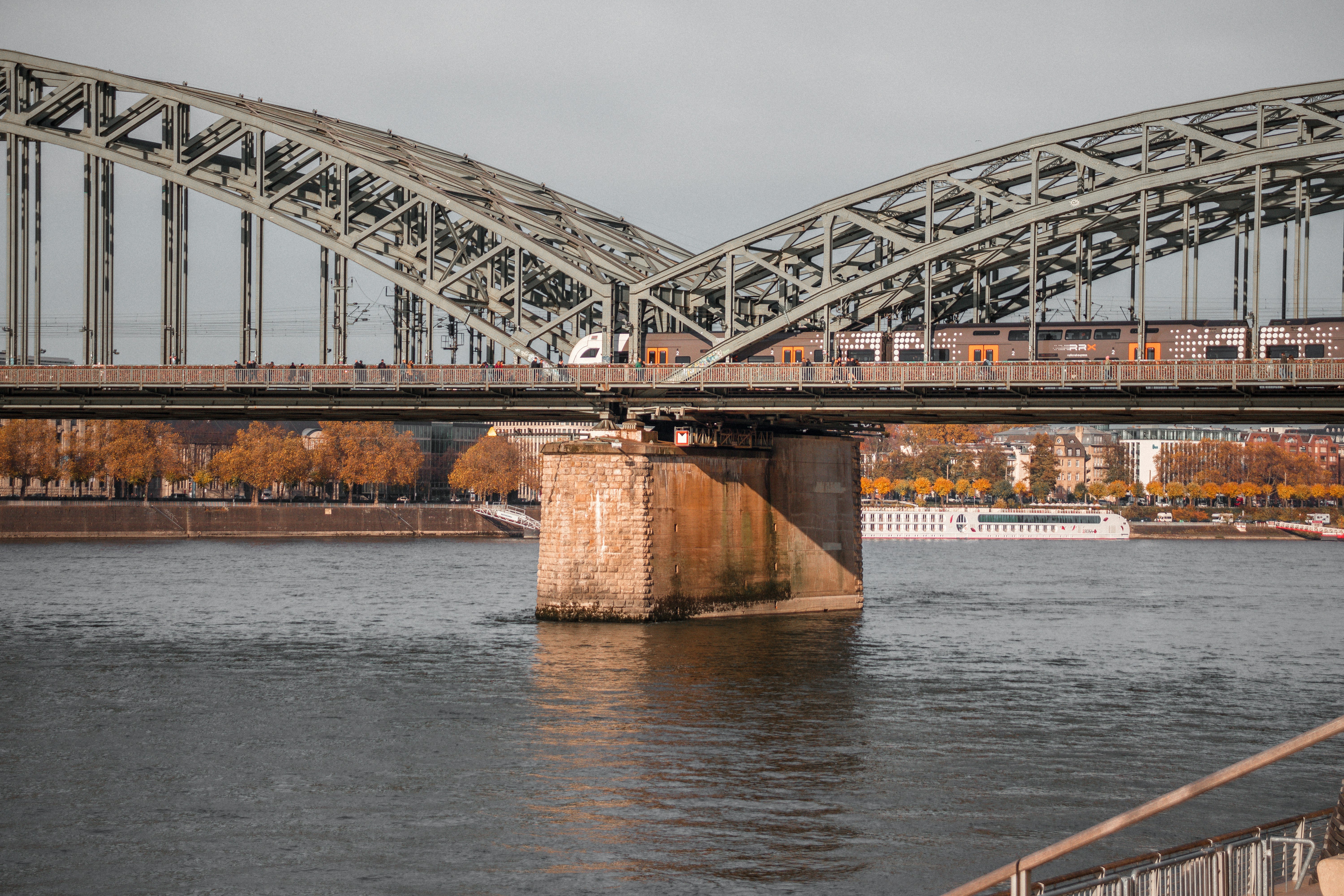 gray iron bridge over a body of water